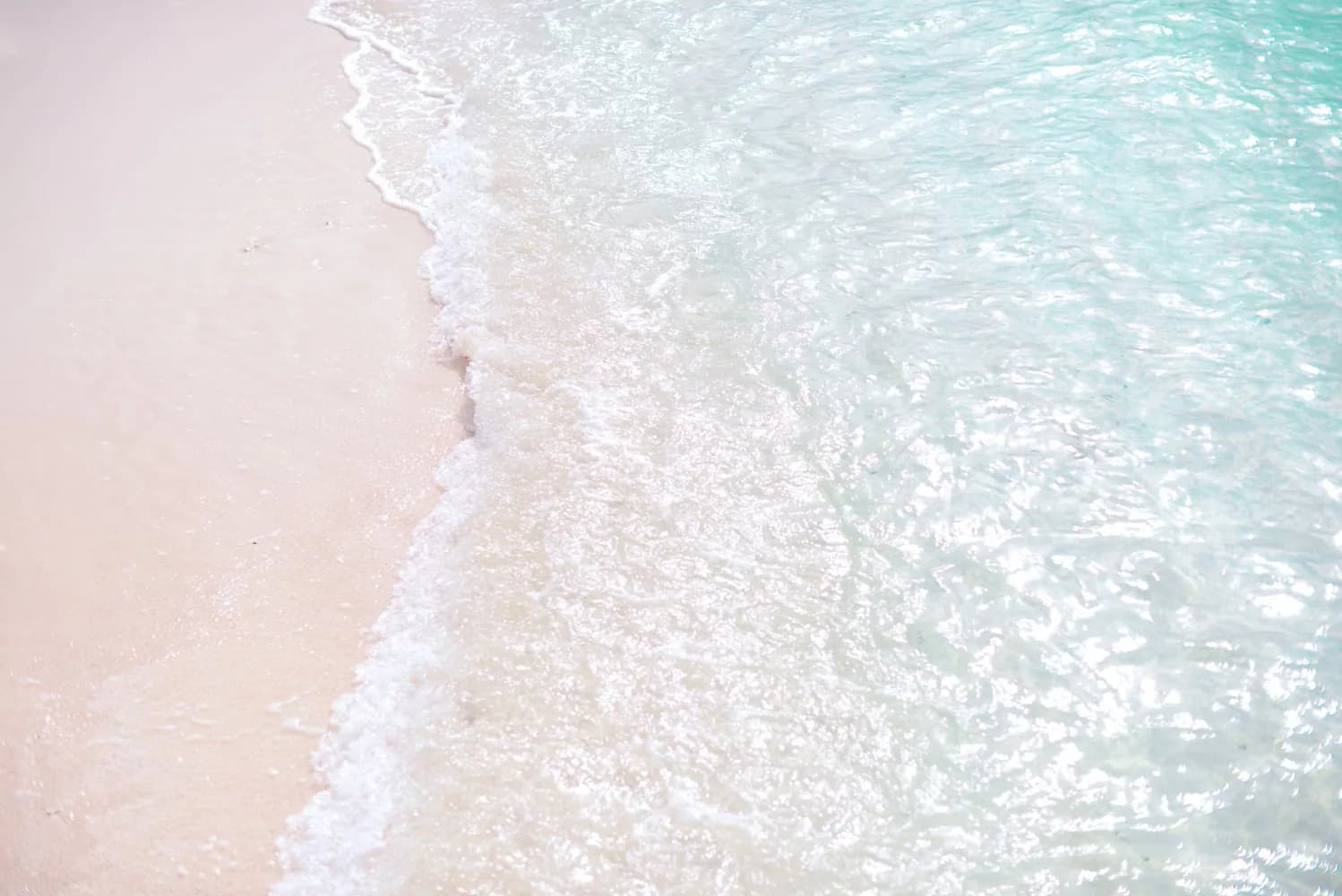 Tranquil white sand beach with clear turquoise water