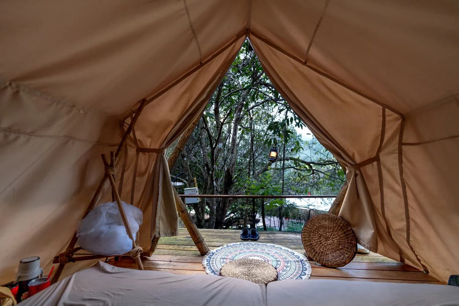 Interior of a plush canvas safari tent overlooking a forest