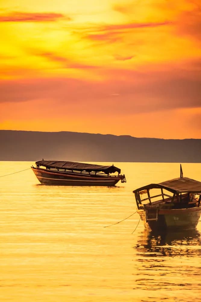 Peaceful boats floating on the golden waters of a Zanzibar sunset