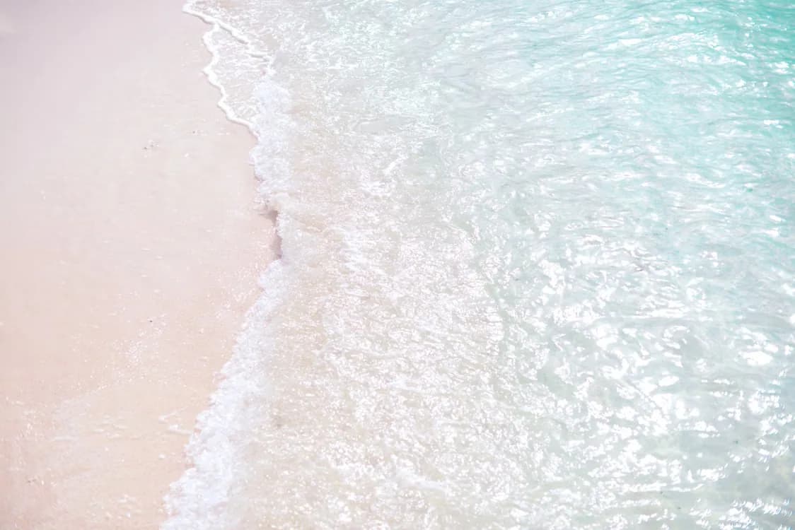 Tranquil white sand beach with clear turquoise water
